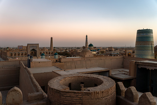 Sunet with panoramic view and Persian architecture in the ancient silk road city of Bukhara, Uzbekistan, Po-i-Kalan Islamic religious complex, Kalyan mosque and Bukhara Tower