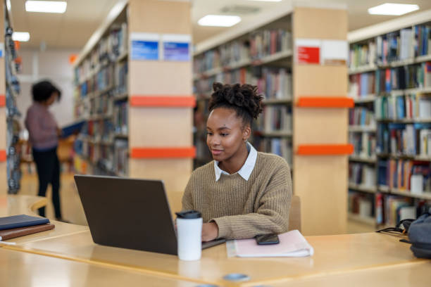 istock African-American Young Lady Reading Information On Her Laptop 1898246722