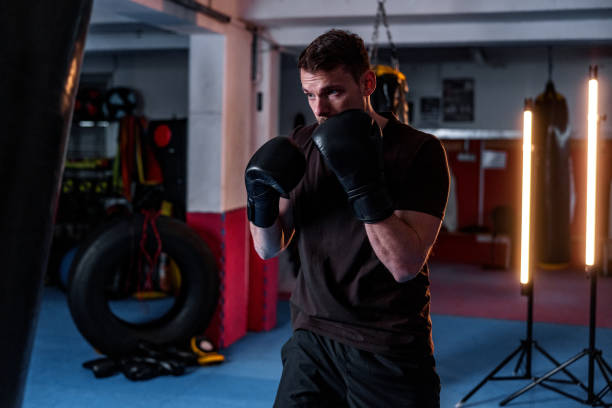 istock Lightweight Young White Male Kickboxer Training At The Gym 1898248907
