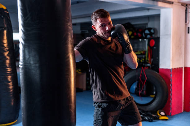 istock Lightweight Young White Male Kickboxer Training At The Gym 1898248911