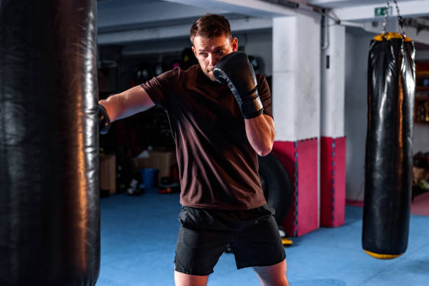 istock Lightweight Young White Male Kickboxer Training At The Gym 1898249419