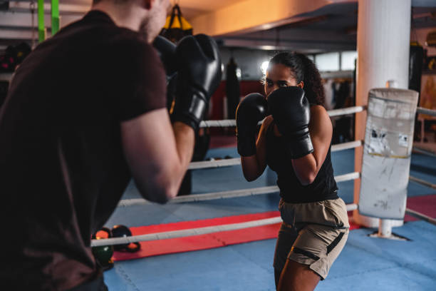 istock Diverse Male And Female Boxers Practicing In A Boxing Ring 1898249443