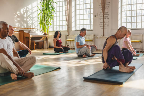istock Multiple Multicultural Yoga Participants Meditating Indoors 1898253792
