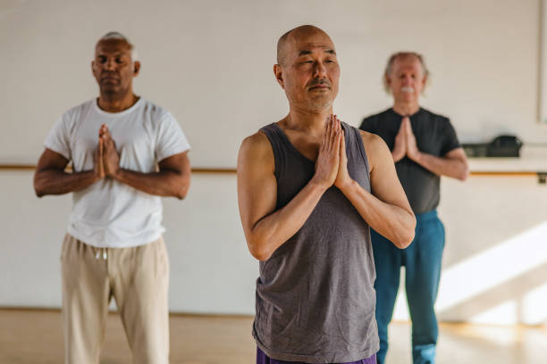 istock Multicultural Mature Men Practicing A Standing Yoga Pose Indoors 1898253814
