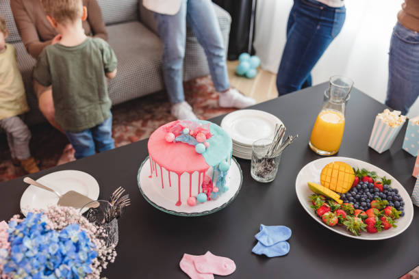 Delicious And Beautiful Cake On A Table Next To Other Snacks At The Gender Reveal Party