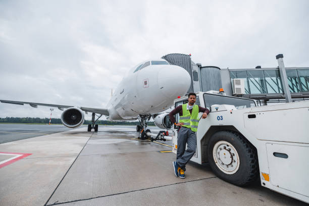 istock An Airport Worker With Passenger Plane In The Background 1898275717