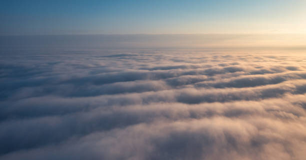 istock Above the Firmament: Dawn's Radiance Above Cottony Clouds 1898311438