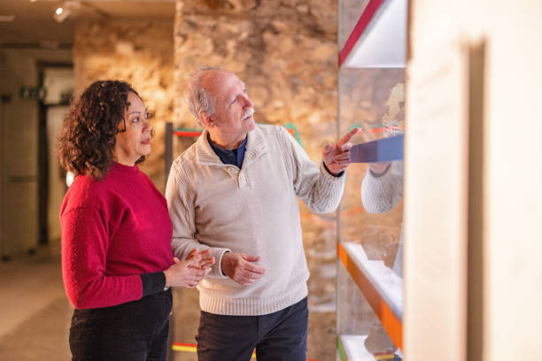 istock Senior Couple Having A Discussion While Looking At Old Artefacts In A History Museum 1898317508