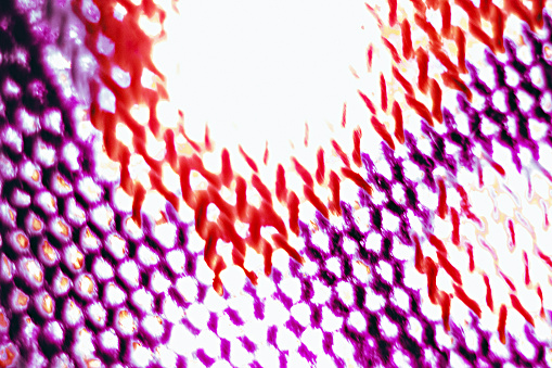 Various small shapes in red and purple, with white shining through them.  There is one large circular beam of light at the top middle section.