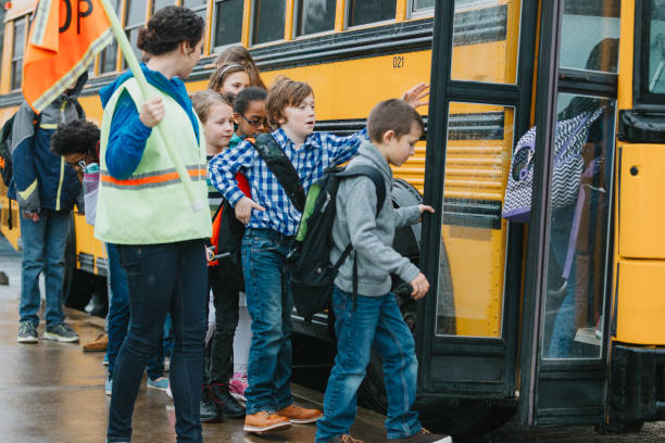 istock Group of children board schoolbus 1898393843