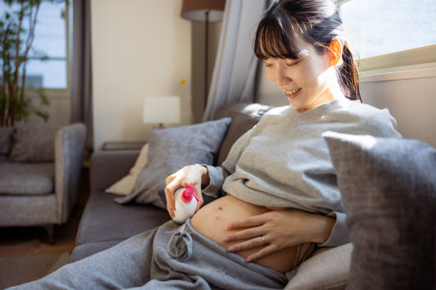 istock Pregnant woman applying moisturizer on her belly 1898506508