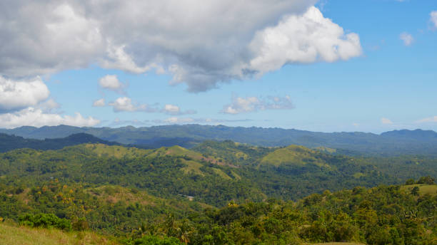 istock panoramic view of a tropical island, mountains, forest, clouds 1898559964