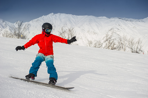Girl snowboarding in bright clothing