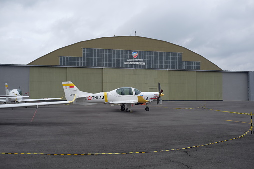 Yogyakarta, Indonesia, Des 2, 2023. The Indonesian Air Force's Grob training aircraft is parked in the hangar yard.