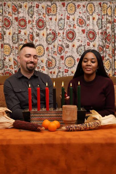 istock Kwanzaa Couple She Lights MS Vertical 1898804735