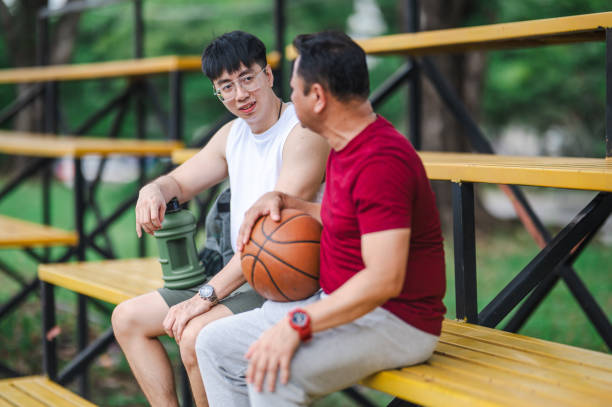 istock On-court Wisdom: Asian Coach Guiding Young Player in Outdoor Session 1898863985