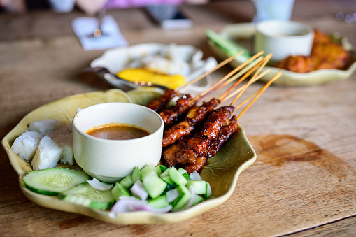 Chicken Satay or Sate Ayam - Asian famous food. Satay, modern Indonesian and Malay spelling of sate, is a dish of seasoned, skewered and grilled meat, served with a peanut sauce