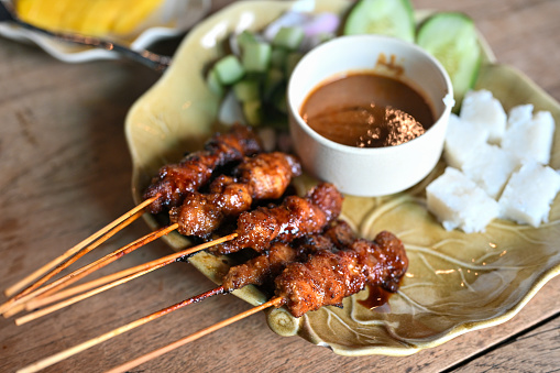 Chicken Satay or Sate Ayam - Asian famous food. Satay, modern Indonesian and Malay spelling of sate, is a dish of seasoned, skewered and grilled meat, served with a peanut sauce