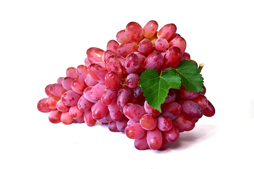 Red grape fruit with green grape leaves on white background.