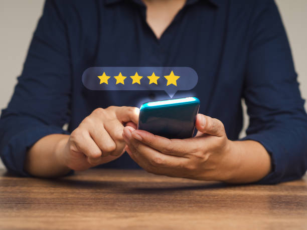 istock Satisfaction and feedback surveys. Customer using a smartphone gives the five-star icon a rating of very impressed for service 1898920164