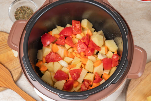istock Modern, bright light multi cooker with raw products. Cooking stewed potatoes with meat in multicooker. Top view of multi cooker with prepared vegetables. 1898952982