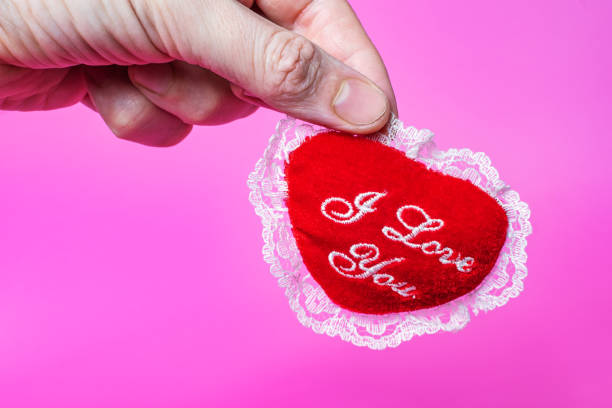 Soft heart in the shape of a toy on a pink background. Concept for Valentine's Day stock photo