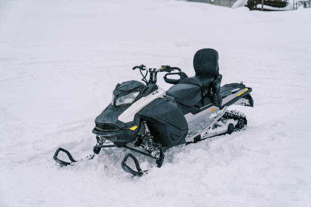 istock Black snowmobile stands on a snowy track 1899000024