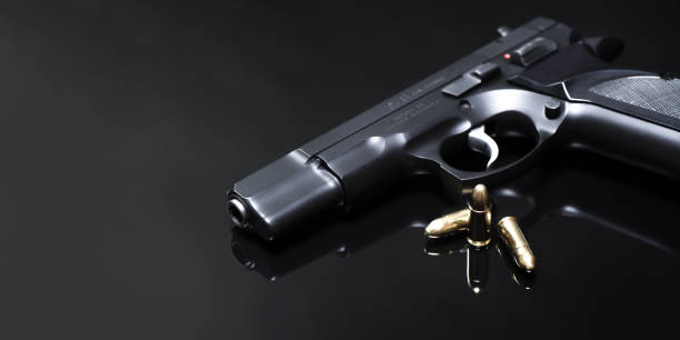 istock 9 mm pistol with Luger JHP ammunitions (dum-dum) on a mirror base. 1899034430
