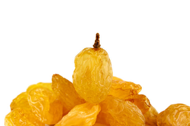 Beautiful golden raisins on a white background.
