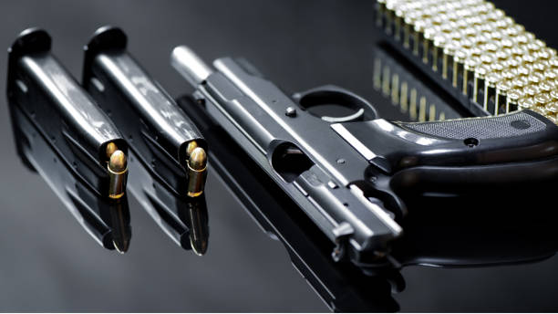 istock Semi automatic pistol with munitions and magazine on black base. 1899040122