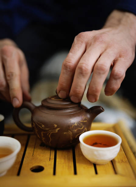 istock Clay teapot and several mugs of tea in a tea ceremony. Tea ceremony 1899043780