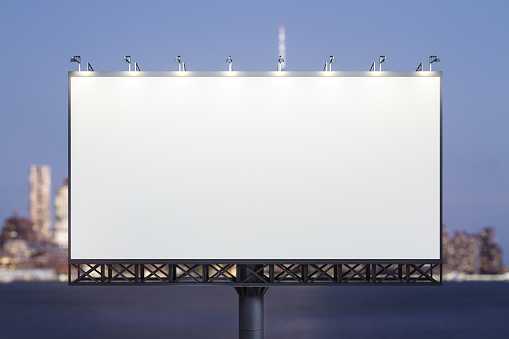 Blank white horizontal billboard on skyline background at evening, front view. Mock up, advertising concept