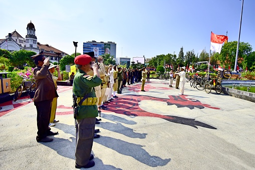 Pyongyang, North Korea - August 15 2012: North Korean soldiers showing their respect to their political leaders at the Grand Monument on Mansu Hill with the bronze statues of Kim II Sung and Kim Jong II.