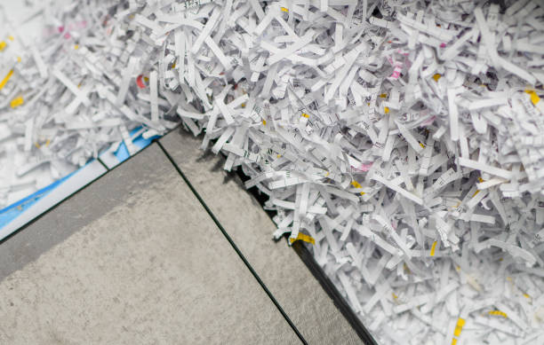 istock Paper cut into pieces in a shredder, company documents destroyed 1899081385