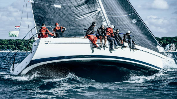 Sailing crew on sailboat in action on regatta. Models and event regatta property released.