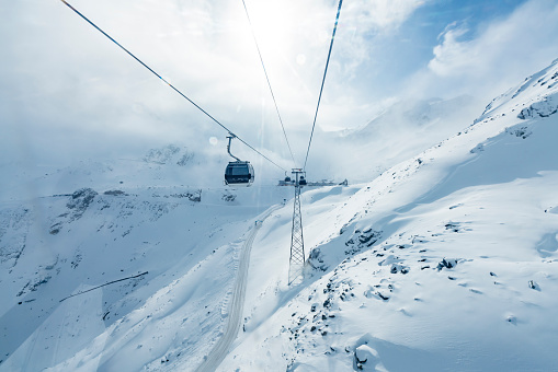 Skiers skiing at winter ski resort Soelden, Tirol, Austria on sunny day.