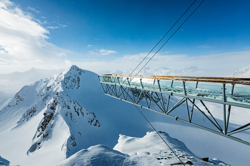 Glass-covered panorama footbridge 20 m long at Tiefenbachkogl 3250 m suspended by steel ropes at winter ski resort, Soelden.