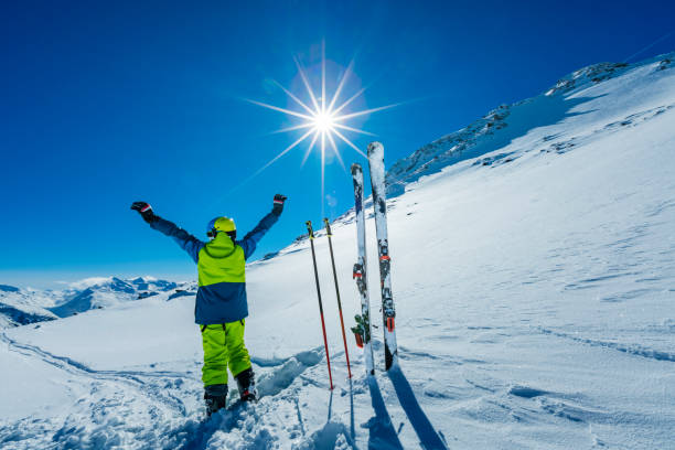 istock Young skier with hands in the air 1899128301