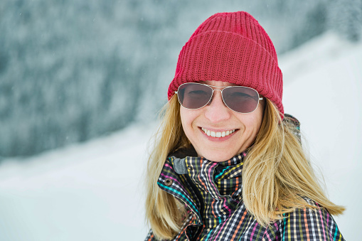 Happy woman at snowcapped park in winter time.