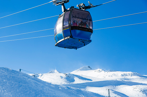 Almaty, Kazakhstan ski lift, cable car cabin at Medeo to Shymbulak route against mountain background