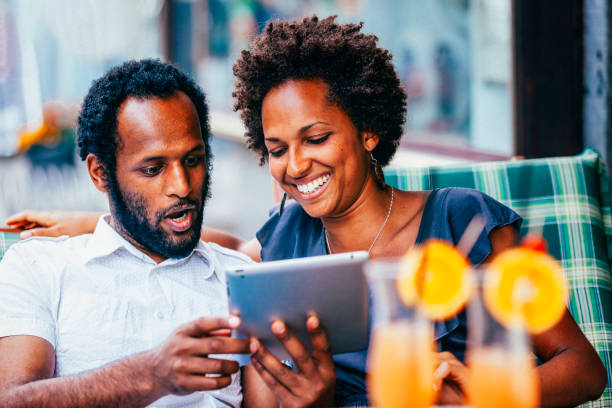 istock Black couple having fun with digital tablet 1899159534