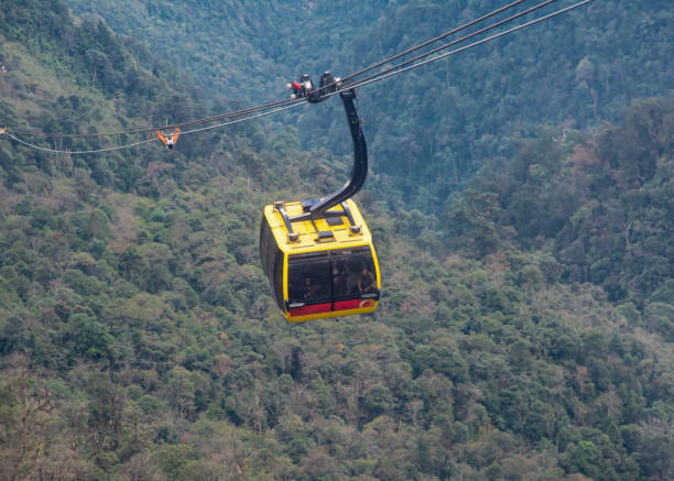 istock Close-up cable car with lush green Hoang Lien Son Range Forest background, breathtaking view to famous Fansipan mountaintop and towering mountains, up to 35 guests each cabin 1899163964