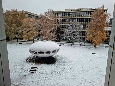 Designed by German architect Stephan Braunfels, the Pinakothek der Moderne was inaugurated in September 2002 after seven years of construction. The image shows the view out of a Window from the museum, captured during winter season.