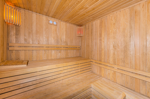 Beautiful sauna room design with a wooden bench in a mansion.