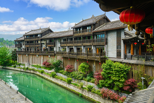 Wooden houses, green rivers, lush vegetation. Beautiful scenery. Zhoushui Ancient Town is a historical and cultural attraction. Chongqing, China.