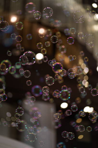 istock Colorful soap bubbles floating in the air with a black background. 1899204680