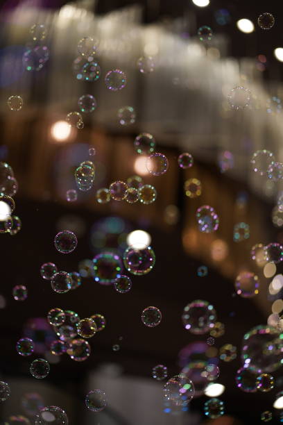 istock Colorful soap bubbles floating in the air with a black background. 1899204688