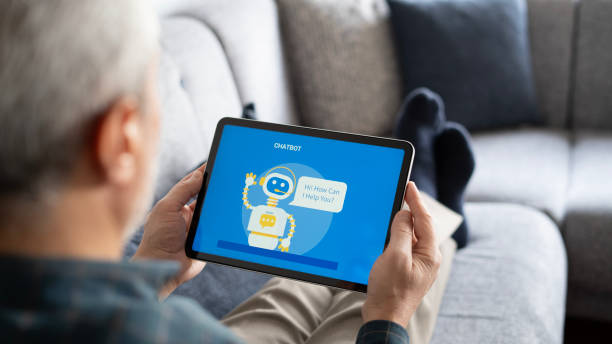 Adult man using chatbot with tablet at home