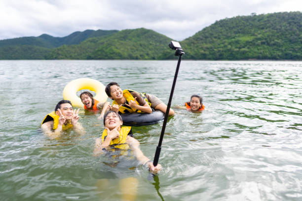 istock Group of Asian people jumping into the lake together. 1899242542