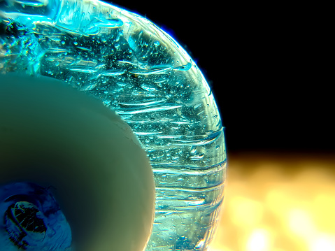 Glass amulet on a black background close-up macro photography